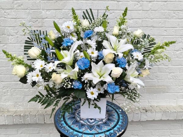 Divine Visitation, white and blue flowers in a porcelain vase.