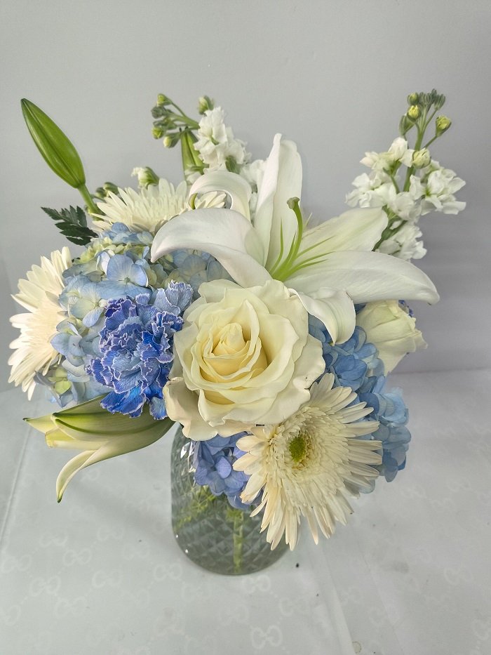 White and blue Hanukkah flowers in a vase.