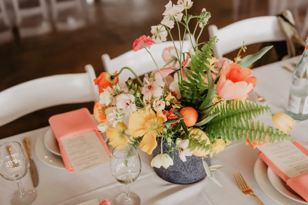A flower arrangement in a vase can be seen on a table