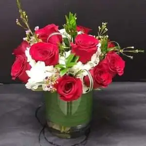 12 red diamonds in a vase.