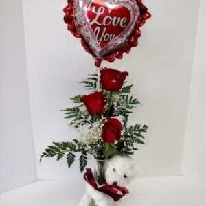 Roses and teddy bear in a bud base.